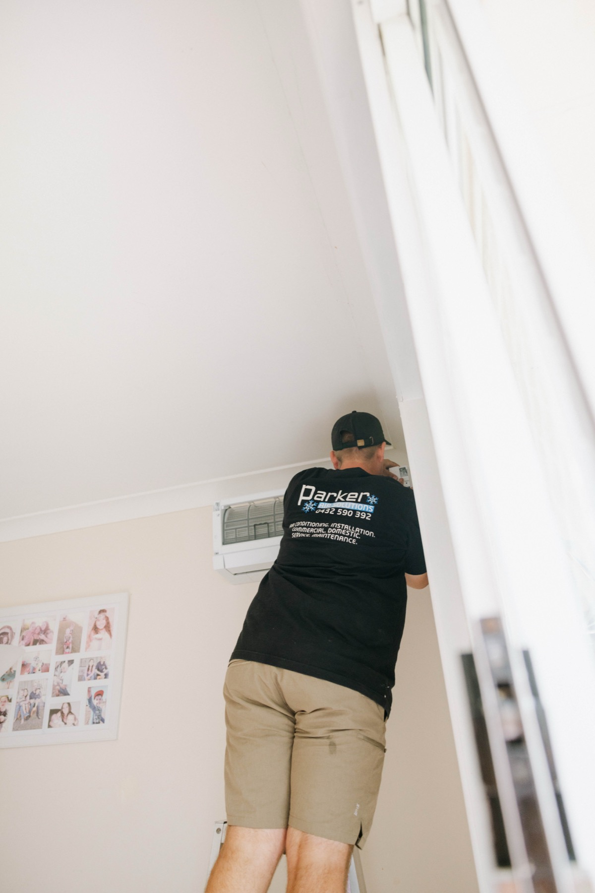 Mitsubishi Electric split system indoor unit being installed in a room