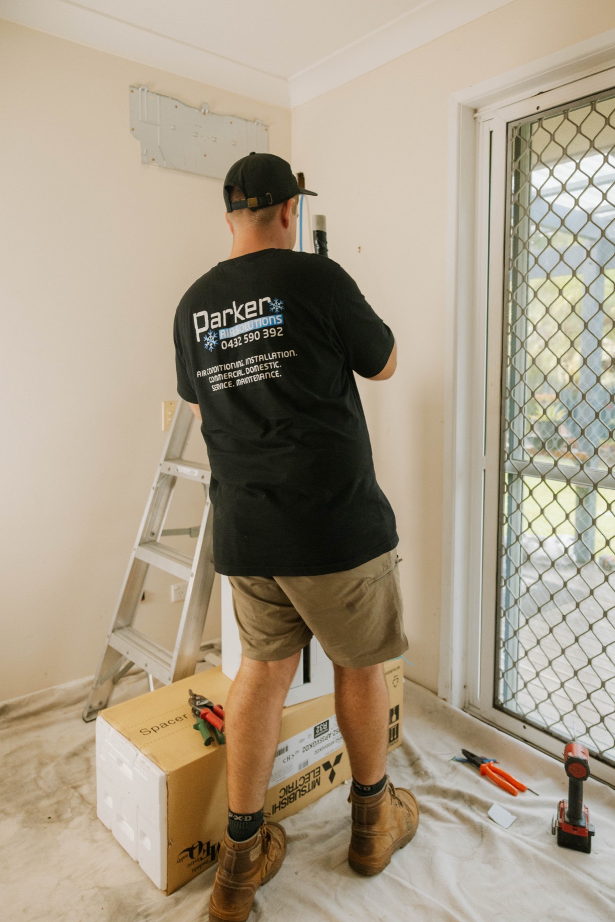 Parker Air technician installing indoor unit wall bracket