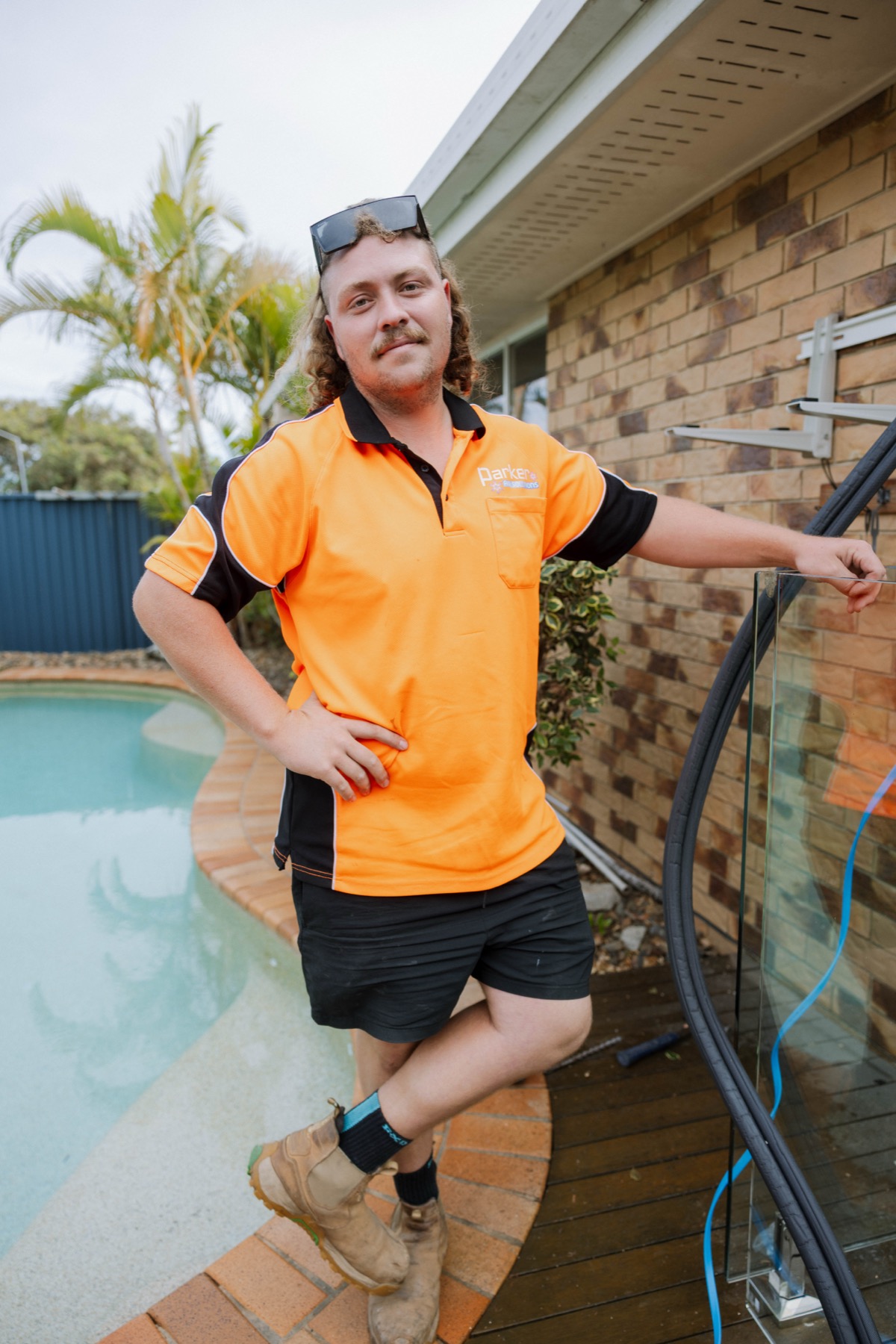 Parker Air technician with refrigerant pipe at Kippa-Ring poolside installation