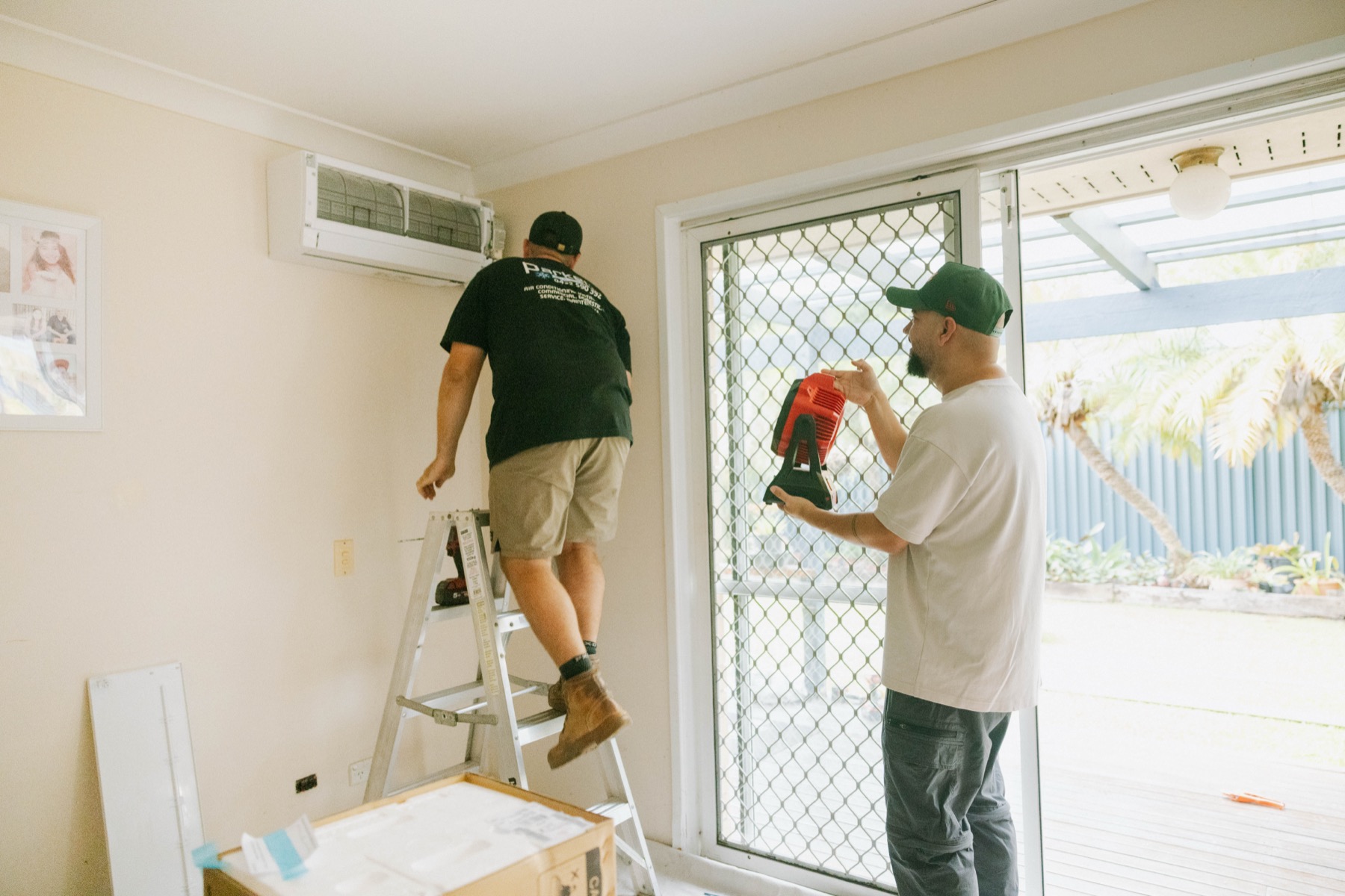Parker Air Solutions team installing a split system indoor unit on a residential job in Brisbane Northside