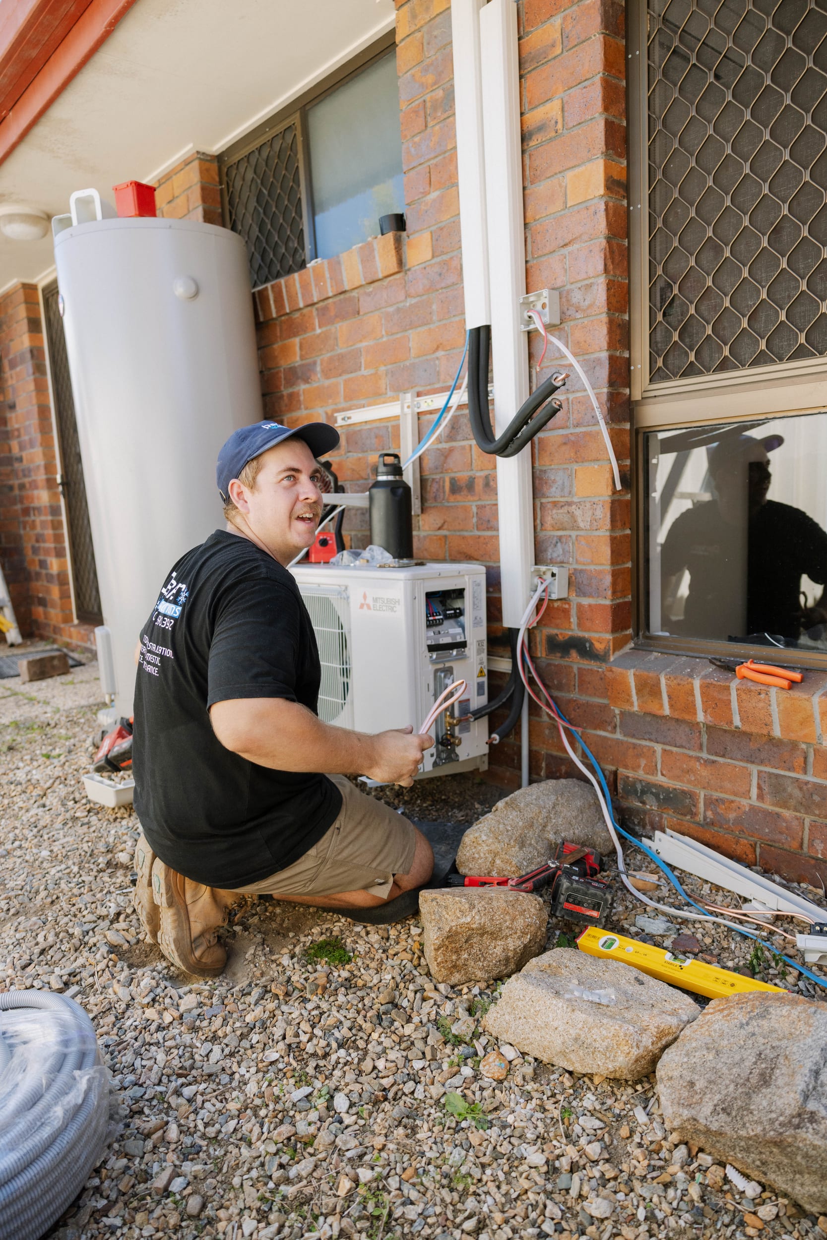 6-star energy efficient Mitsubishi Electric outdoor unit installation close-up