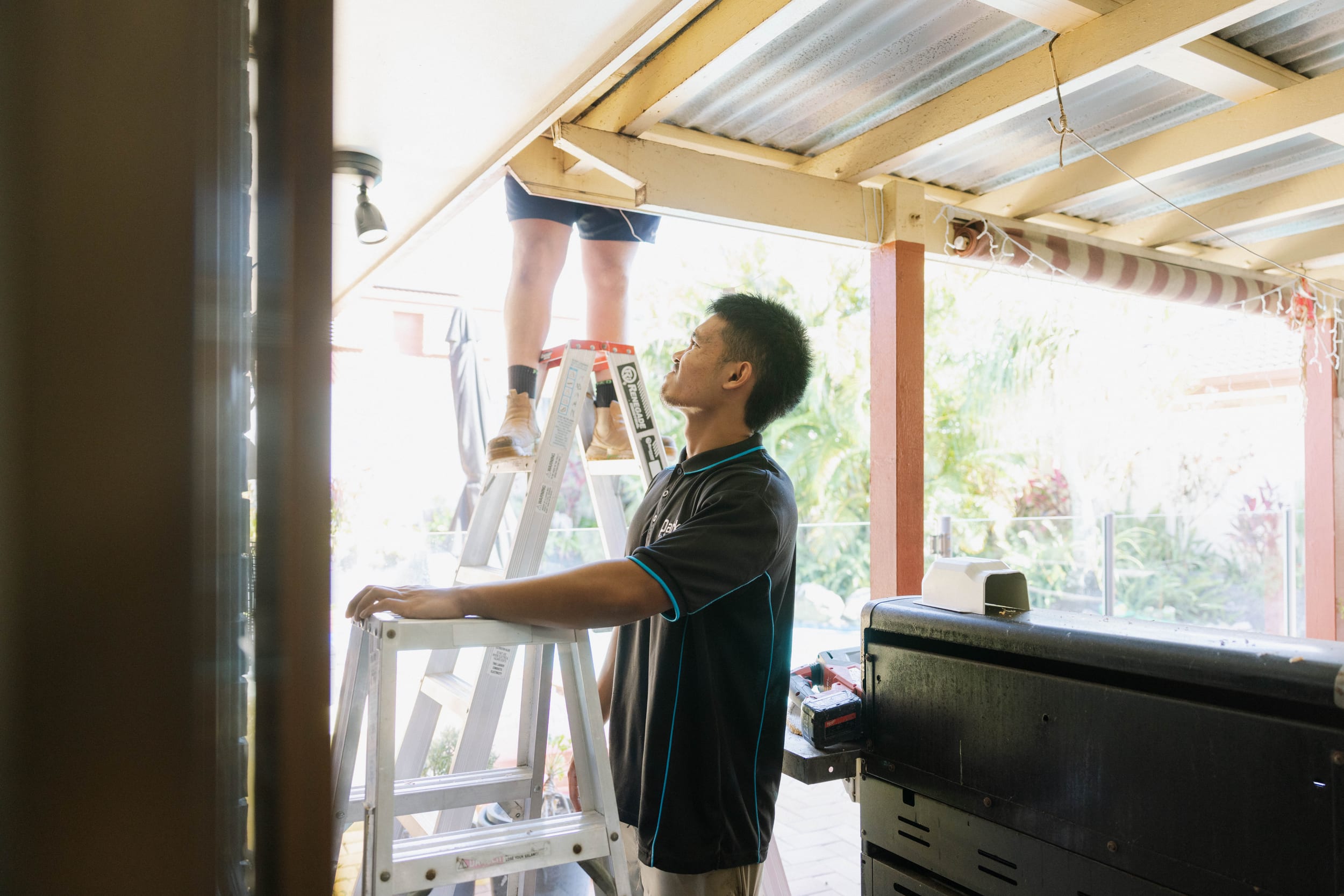Two Parker Air Solutions technicians collaborating on a McDowall split system installation
