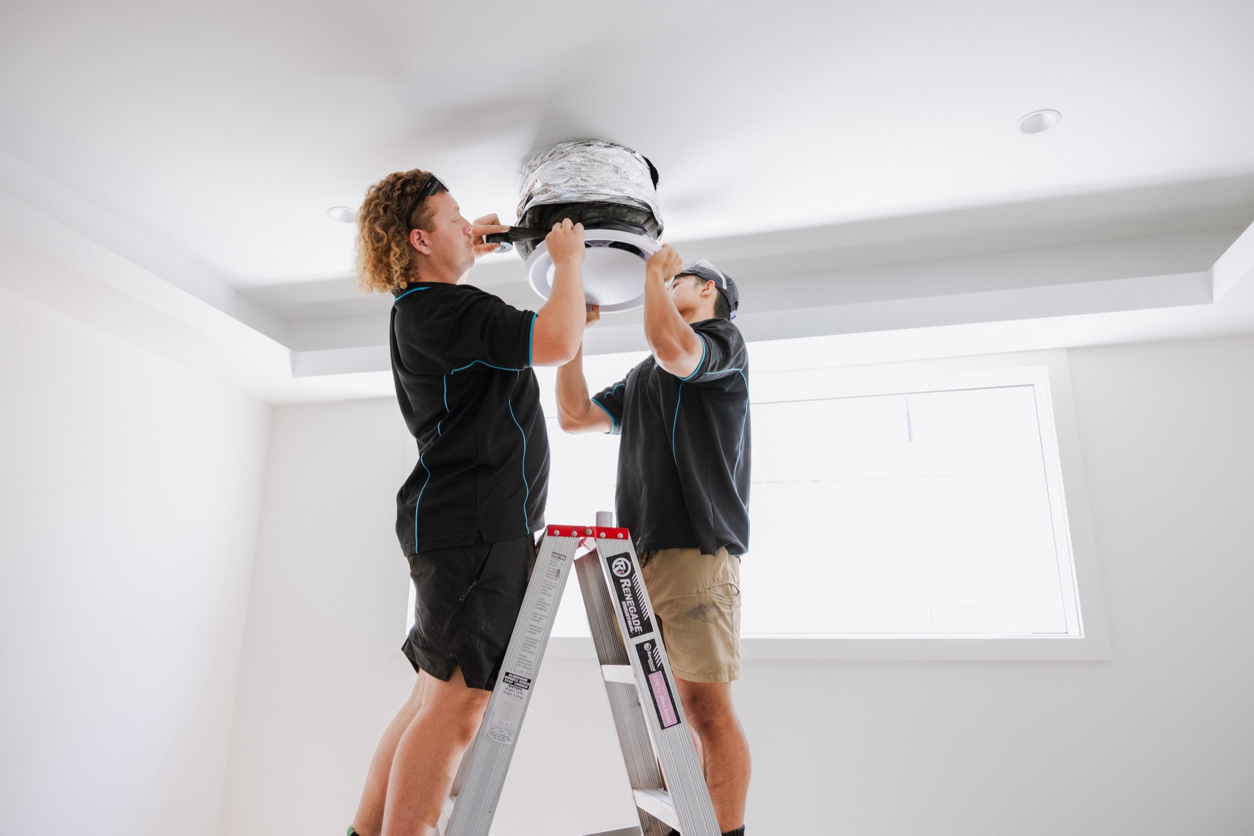 Parker Air Solutions team installing ducted air conditioning